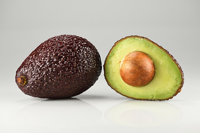 whole and halved Hass avocado: Credit, Wikimedia Commons whole and halved Hass avocado